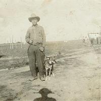  James Lee Tracy with dog, Coyote. Jim was the son of James Leonard Tracy (1867-1937) and Leona Lee Turner (1866-1955) and the brother of Sanford (Sant) Perry Tracy.